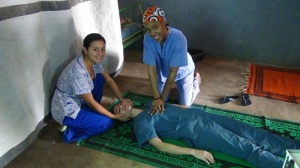 That is Laure doing chest compressions on Patricia, with Diana demonstrating the jaw thrust and airway management.